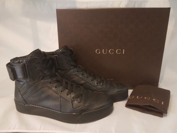 Luxurious pre-owned Gucci high top trainers in black leather with logo embroidery. Includes box and dust bag.