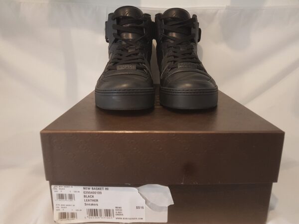 Luxurious pre-owned Gucci high top trainers in black leather with logo embroidery. Includes box and dust bag.