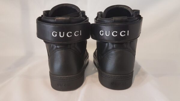 Luxurious pre-owned Gucci high top trainers in black leather with logo embroidery. Includes box and dust bag.