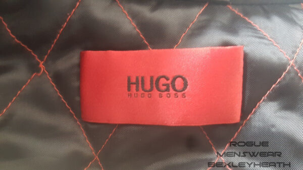 Stylish pre-loved black Hugo Boss trench coat, a timeless piece for the fashion-forward individual